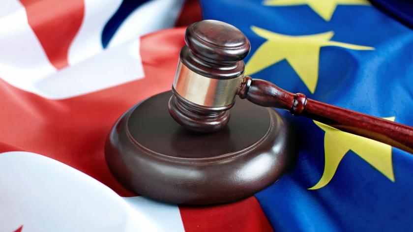 Gavel on top of British and European flags
